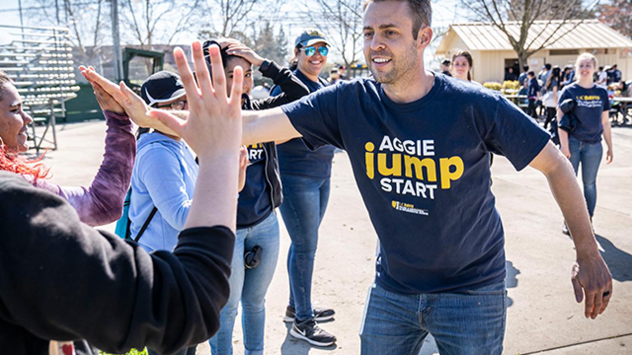 Craig high fives a student.
